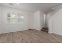 Bright living room featuring wood-look tile floors and a large window at 1857 W 22Nd Ave, Apache Junction, AZ 85120