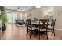 Open-concept dining and living area with tile floors, a ceiling fan, plenty of natural light and outdoor access at 20556 W Point Ridge Rd, Buckeye, AZ 85396