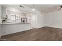 Open-concept view showcases the stainless steel appliances and quartz countertop in a kitchen with white cabinets at 2315 N 52Nd St # 144, Phoenix, AZ 85008