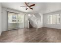 Bright, airy living room features wood floors, ceiling fan, and sliding doors to a balcony at 2315 N 52Nd St # 144, Phoenix, AZ 85008