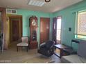 A view of the living room with vintage furniture and a grandfather clock at 2414 W Cholla St, Phoenix, AZ 85029