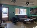 Cozy living room featuring vintage furniture, a ceiling fan, and good natural light at 2414 W Cholla St, Phoenix, AZ 85029