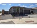 Beautiful one-story home featuring a stone-accented facade, well-maintained landscaping, and an attached garage at 25096 N 154Th Ln, Surprise, AZ 85387