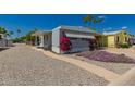 Exterior view of the home with a covered parking space and sidewalk leading to the entrance at 2650 W Union Hills Dr # 16, Phoenix, AZ 85027