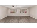 Spacious living room with modern wood-look flooring and plenty of natural light from the windows at 2650 W Union Hills Dr # 16, Phoenix, AZ 85027