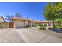 Charming single-story home with a well-manicured, low maintenance front yard and private two car garage at 2845 E Irwin Ave, Mesa, AZ 85204