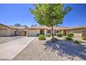 Charming single-story home with a well-manicured, low maintenance front yard and private two car garage at 2845 E Irwin Ave, Mesa, AZ 85204