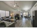 Bright and open living room featuring vaulted ceilings, neutral paint, wood-look floors, and large windows at 2845 E Irwin Ave, Mesa, AZ 85204