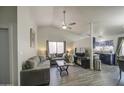 Bright and open living room featuring vaulted ceilings, neutral paint, wood-look floors, and large windows at 2845 E Irwin Ave, Mesa, AZ 85204