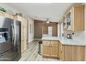 Bright kitchen with stainless steel refrigerator and light wood cabinets at 3301 S Goldfield Rd # 1010, Apache Junction, AZ 85119
