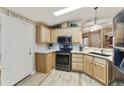 Well-equipped kitchen with black appliances, granite countertops, and wood cabinets at 3301 S Goldfield Rd # 1010, Apache Junction, AZ 85119