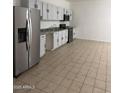 Bright kitchen featuring stainless steel appliances, white cabinets, and tile flooring at 4049 N 81St Ave, Phoenix, AZ 85033