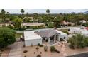 Aerial view of home showcasing landscaping, unique architecture, desert surroundings, and neighborhood at 5438 E Lupine Ave, Scottsdale, AZ 85254