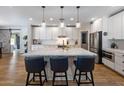 Charming kitchen featuring a large center island, stainless appliances, and white cabinetry at 5926 E Hartford Ave, Scottsdale, AZ 85254