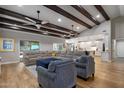 Open-concept living area boasts hardwood floors, beamed ceilings, and seamlessly connects to the kitchen at 5926 E Hartford Ave, Scottsdale, AZ 85254