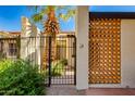 Gated entrance with desert landscaping, accent walls, and sunny skies at 6 E Manzanita Dr, Phoenix, AZ 85020