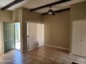 Cozy living room features a ceiling fan, exposed beams and stylish tiled flooring at 603 S Allred Dr, Tempe, AZ 85281