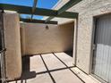 Covered patio with a stucco wall, beam overhang, and sliding glass door at 603 S Allred Dr, Tempe, AZ 85281