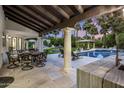 Inviting outdoor patio with a pool, dining area, and beautiful landscaping, ideal for entertaining at 6611 N 64Th Pl, Paradise Valley, AZ 85253
