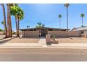 Modern single story home with palm trees and desert landscaping at 7604 N 46Th Ave, Glendale, AZ 85301
