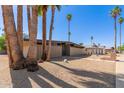 Modern single story home with desert landscaping and mature trees at 7604 N 46Th Ave, Glendale, AZ 85301