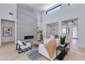 Bright living room with soaring ceilings, a modern fireplace, and open floor plan at 8300 E Dixileta Dr # 306, Scottsdale, AZ 85266