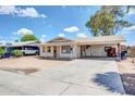A single-story home features a spacious concrete driveway and a covered front porch with columns at 875 E Flint St, Chandler, AZ 85225
