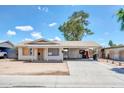 Single-story home with an expansive driveway and covered front porch with supporting columns at 875 E Flint St, Chandler, AZ 85225
