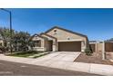 Attractive stucco home with well-maintained landscaping, concrete drive, and easy street access at 94 S 189Th Ln, Buckeye, AZ 85326