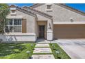 Inviting home with stone pathway, artificial grass, and a welcoming front door at 94 S 189Th Ln, Buckeye, AZ 85326