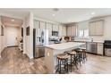Modern kitchen with stainless steel appliances, quartz countertops, and wood-look tile floors at 94 S 189Th Ln, Buckeye, AZ 85326