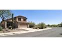Charming two-story home featuring a two-car garage and desert landscaping at 10399 E Hillery Dr, Scottsdale, AZ 85255