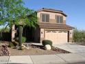 Charming two-story home featuring a two-car garage and desert landscaping at 10399 E Hillery Dr, Scottsdale, AZ 85255