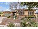 Attractive single-story home featuring low-maintenance landscaping and stone accents at 13720 N 148Th Dr, Surprise, AZ 85379