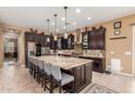 Spacious kitchen features a large island with bar seating, stainless steel appliances, and plenty of cabinet space at 13720 N 148Th Dr, Surprise, AZ 85379