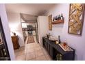 Bright dining area with modern bar, wine rack and view of kitchen in background at 16021 N 30Th St # 127, Phoenix, AZ 85032