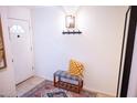 Cozy entryway with decorative bench, patterned rug, and stylish light fixture at 16021 N 30Th St # 127, Phoenix, AZ 85032