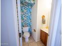 Charming powder room boasts tropical leaf wallpaper, adding a vibrant touch and a modern sink at 16021 N 30Th St # 127, Phoenix, AZ 85032