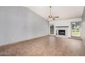 Bright living room featuring tile flooring, a ceiling fan, and a cozy fireplace at 17830 N 45Th Ave, Glendale, AZ 85308