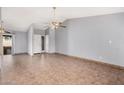 Spacious living room with tile floors, ceiling fan, and ample natural light at 17830 N 45Th Ave, Glendale, AZ 85308