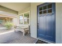 Close-up view of a blue front door with glass windows and a covered porch at 18066 N Stonegate Rd, Maricopa, AZ 85138