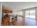 Open-concept area showcasing a kitchen island, dining space, and seamless access to the outdoor living space at 18137 W Deer Creek Rd, Goodyear, AZ 85338