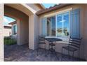 Relaxing covered patio with brick flooring, perfect for outdoor seating and enjoying the fresh air at 18137 W Deer Creek Rd, Goodyear, AZ 85338
