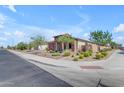 Corner lot home featuring desert landscaping, stone accents and a neutral color palette with a tile roof at 18362 W Illini St, Goodyear, AZ 85338