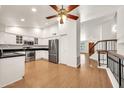 Bright kitchen with white cabinets, stainless appliances, granite countertops, and wood flooring at 1903 E Jasper Dr, Chandler, AZ 85225