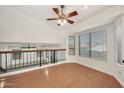 Bright living room features new laminate wood flooring, windows, and a modern ceiling fan at 1903 E Jasper Dr, Chandler, AZ 85225