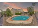 A backyard featuring a private pool, patio, and gazebo, perfect for outdoor entertaining and relaxation at 1903 E Jasper Dr, Chandler, AZ 85225