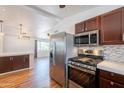 Open-concept kitchen with stainless steel appliances and a bar area overlooking the adjacent living space at 2214 N 7Th Ave, Phoenix, AZ 85007