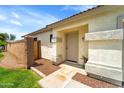 A close up of the front door and porch features desert landscaping and a neutral color palette at 2221 E Union Hills Dr # 148, Phoenix, AZ 85024