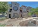 Three-story townhomes featuring private entrances, desert landscaping, and neutral stucco at 2402 E 5Th St # 1520, Tempe, AZ 85288